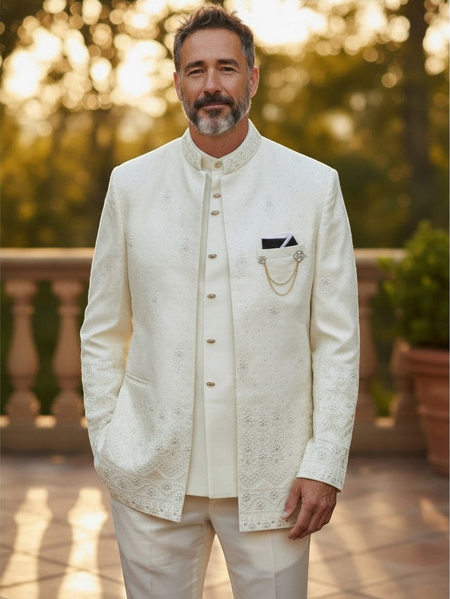 Man wearing a Kurti Connection USA off-white three-piece Indo-Western sherwani with intricate embroidery and gold chain