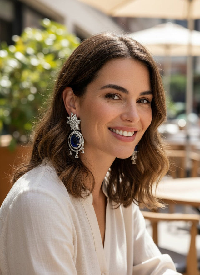 Kurti Connection USA ornate silver drop earrings with blue carved stones and clear cubic zirconia accents.