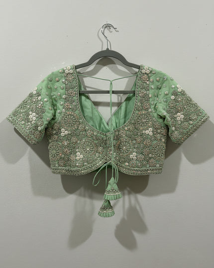 Posts green color blouse