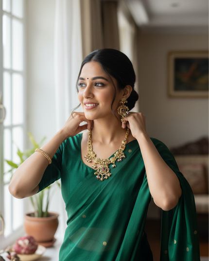 Kurti Connection USA antique finish gold necklace set with intricate detailing worn by a woman in a green saree