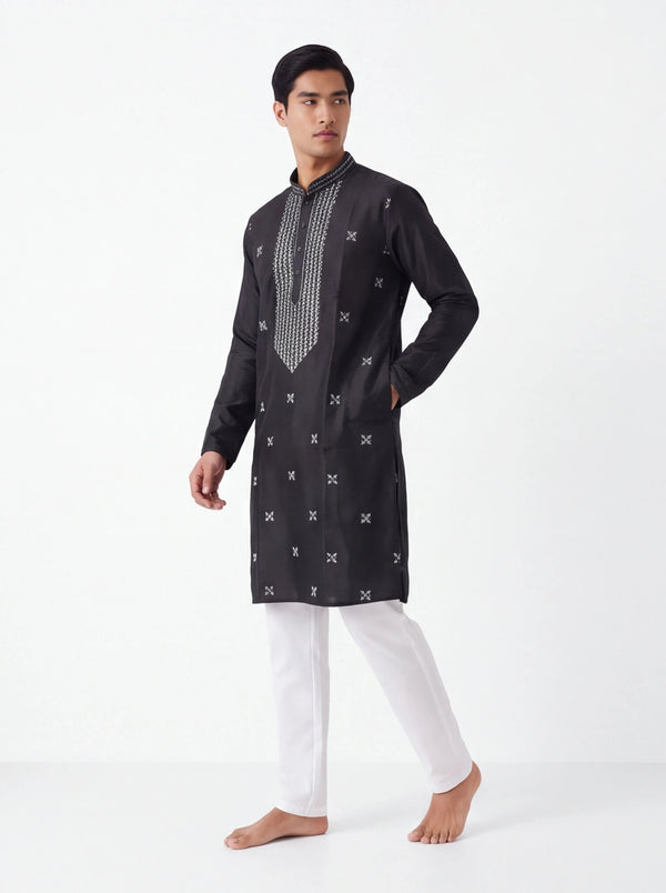 Kurti Connection USA black silk kurta with white geometric embroidery, mandarin collar, and white trousers on a model