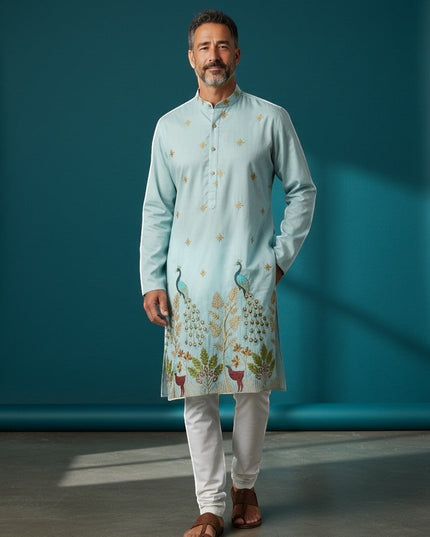 Kurti Connection USA light blue silk kurta set with intricate peacock and deer embroidery, paired with white pajama.