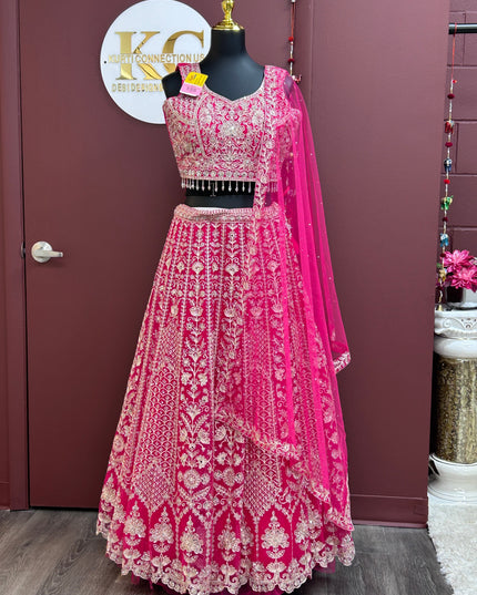 Kurti Connection USA dark pink lehenga choli set with intricate gold embroidery and matching sheer dupatta on mannequin