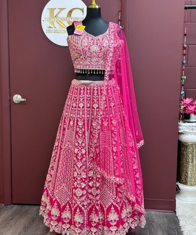 Kurti Connection USA dark pink lehenga choli set with intricate gold embroidery and matching sheer dupatta on mannequin