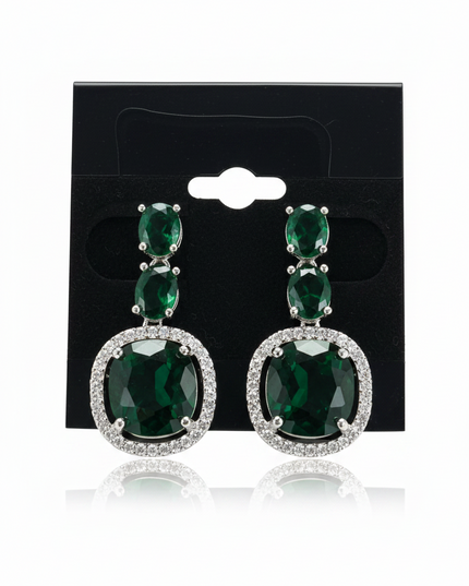 Kurti Connection USA emerald green oval crystal drop earrings with silver-tone halo setting on a black display card.