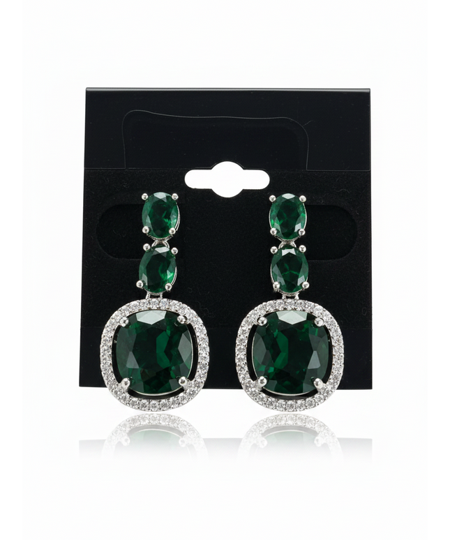 Kurti Connection USA emerald green oval crystal drop earrings with silver-tone halo setting on a black display card.