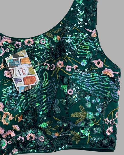 Kurti Connection USA sleeveless emerald green crop top with intricate floral embroidery and shimmering sequin details.