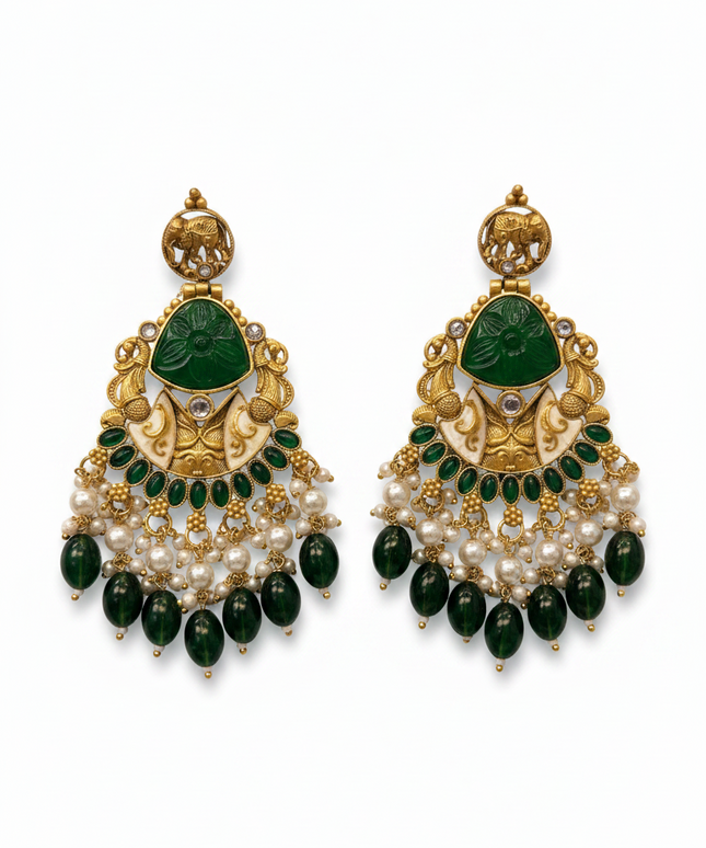 Kurti Connection USA gold-toned jhumki earrings with green stone inlay, elephant motif, and pearl bead dangles.
