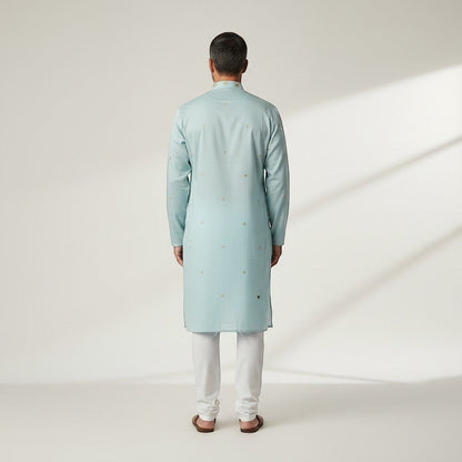 Kurti Connection USA light blue silk kurta set with subtle gold embroidery and white pajama, worn by a man.