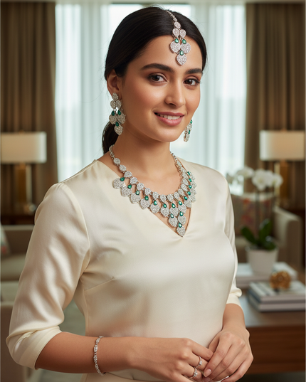 Kurti Connection USA necklace set featuring white stones and green teardrop accents worn by a woman in a cream top
