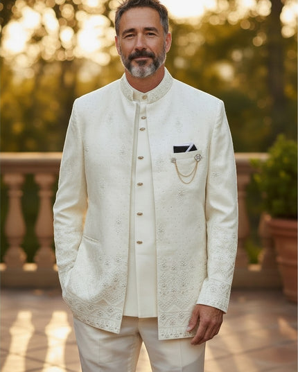 Man wearing a Kurti Connection USA off-white three-piece Indo-Western sherwani with intricate embroidery and gold chain