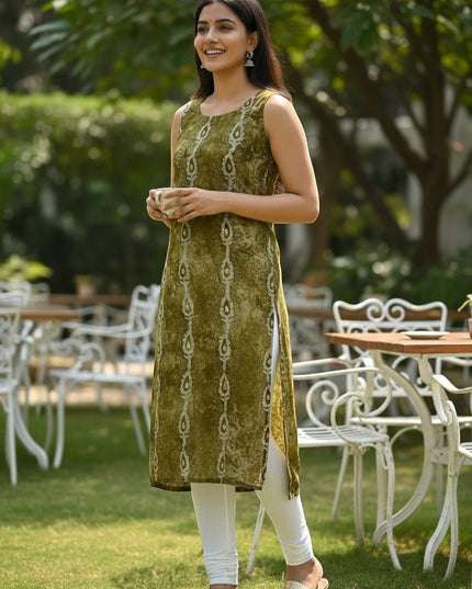 Kurti Connection USA sleeveless olive green printed straight kurti with white leggings and gold sandals.
