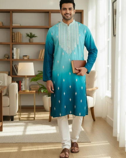Kurti Connection USA men's ombre turquoise to teal kurta with white embroidery and trousers in a bright home office.