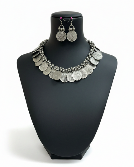 Kurti Connection USA oxidized silver coin necklace and matching drop earring set on a black display bust