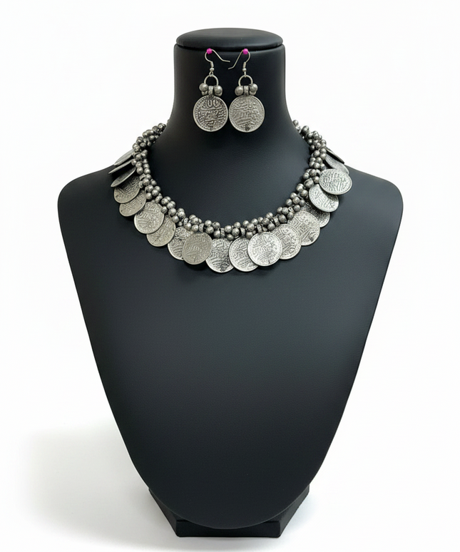 Kurti Connection USA oxidized silver coin necklace and matching drop earring set on a black display bust