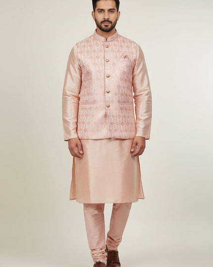 Man wearing a Kurti Connection USA peach kurta set with a patterned Nehru jacket and matching trousers