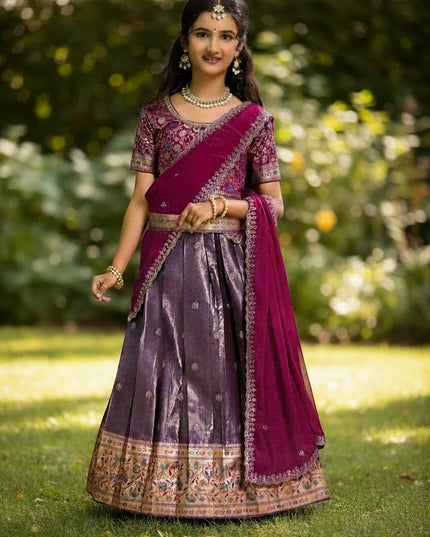 Young girl wearing a purple and magenta Kurti Connection USA pattu lehenga with intricate gold embroidery and dupatta
