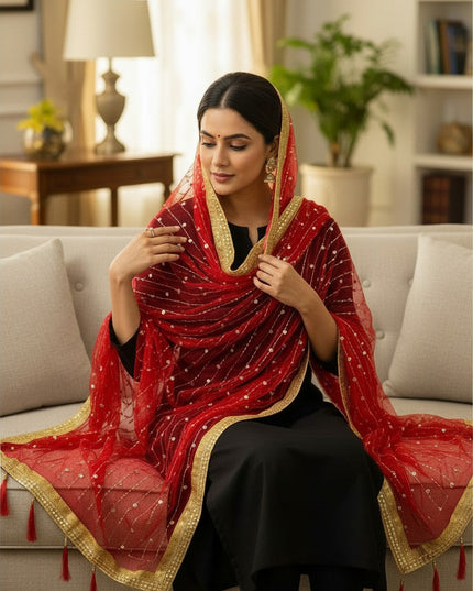Kurti Connection USA red net dupatta with gold border, sequin embroidery, and tassels draped over a woman's head.