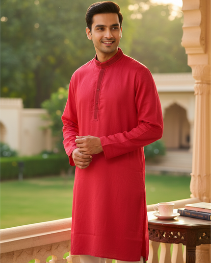 Kurti Connection USA men's red poly silk kurta with textured fabric and mandarin collar, worn by a smiling man.