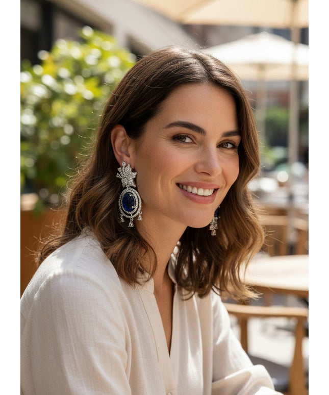 Kurti Connection USA ornate silver drop earrings with blue carved stones and clear cubic zirconia accents.