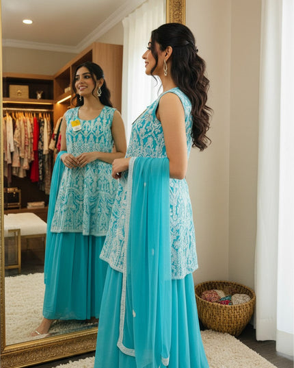 Woman wearing a Kurti Connection USA turquoise georgette sleeveless kurti with white embroidery and matching sharara