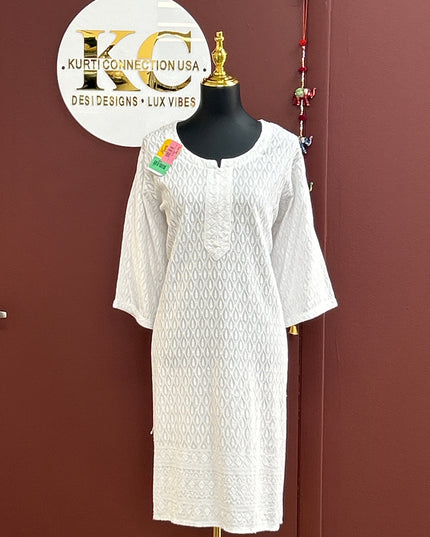 Kurti Connection USA white Chikankari kurti with intricate Lucknowi hand-embroidery, round neckline, and 3/4 sleeves.